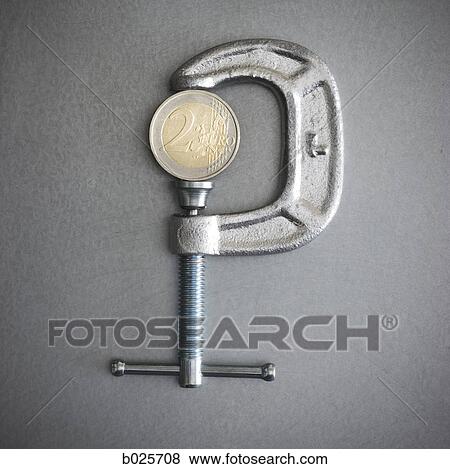 two euro coin in a clamp View Large Photo Image Stock Photo - two euro coin in a clamp. Fotosearch