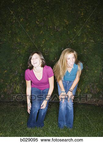 Stock Photography - two friends in the backyard at night. Fotosearch