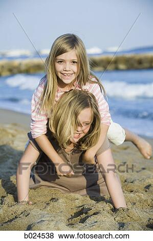 Stock Photo - two girls at the beach. Fotosearch