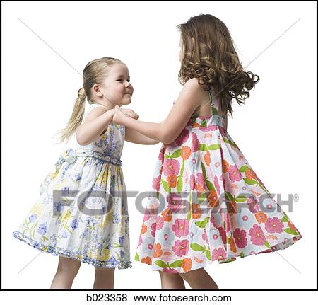 two girls dancing in dresses View Large Photo Image Stock Photo - two girls dancing in dresses. Fotosearch