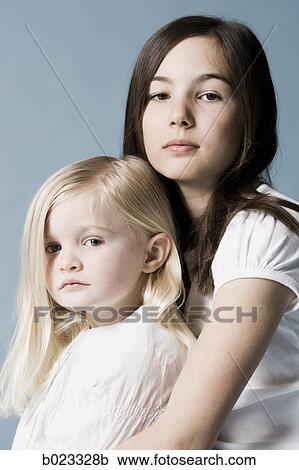 two girls looking at the camera View Large Photo Image Stock Image - two girls looking at the camera. Fotosearch