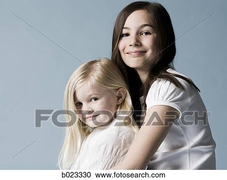 two girls looking at the camera View Large Photo Image Stock Image - two girls looking at the camera. Fotosearch