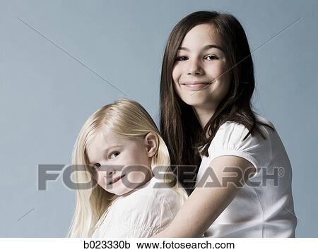 two girls looking at the camera View Large Photo Image Stock Image - two girls looking at the camera. Fotosearch