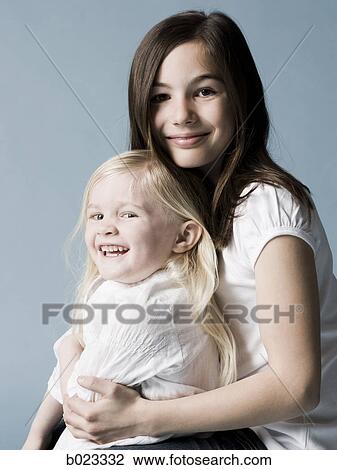 two girls looking at the camera View Large Photo Image Stock Image - two girls looking at the camera. Fotosearch