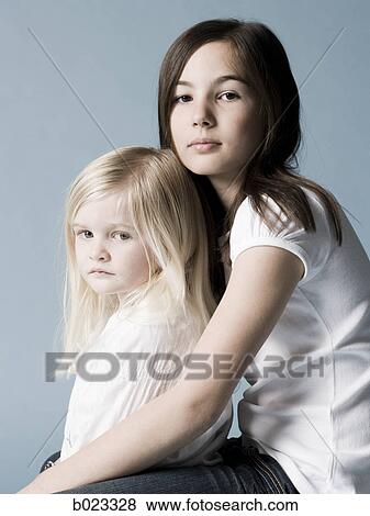 Stock Photo - two girls looking at the camera. Fotosearch