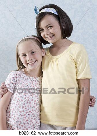 Stock Image - two girls standing together. Fotosearch