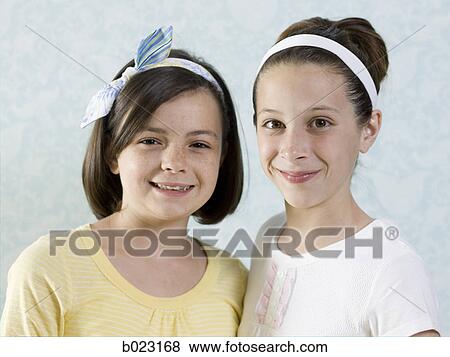two girls standing together View Large Photo Image Stock Photo - two girls standing together. Fotosearch