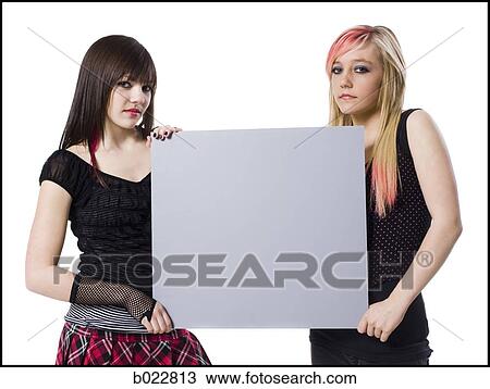 Stock Image - two rocker girls holding a sign. Fotosearch