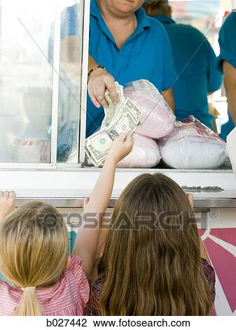 two sisters buying cottong candy at the carnival View Large Photo Image Stock Image - two sisters buying cottong candy at the carnival. Fotosearch