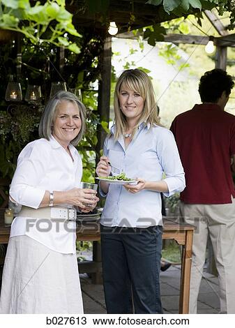 two women eating outdoors View Large Photo Image Stock Image - two women eating outdoors. Fotosearch