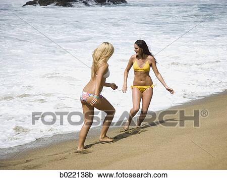 two young women at the beach View Large Photo Image Stock Image - two young women at the beach. Fotosearch