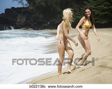 two young women at the beach View Large Photo Image Stock Image - two young women at the beach. Fotosearch
