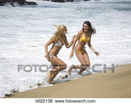two young women at the beach View Large Photo Image Stock Photo - two young women at the beach. Fotosearch