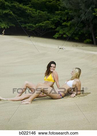 Stock Photograph - two young women at the beach. Fotosearch