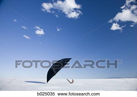 Stock Photography - umbrella in the middle of nowhere. Fotosearch
