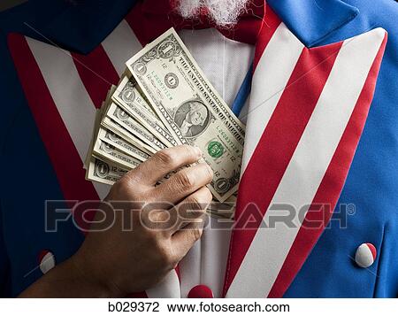 uncle sam putting money into his coat View Large Photo Image Stock Image - uncle sam putting money into his coat. Fotosearch