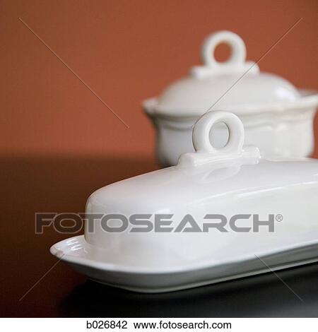 Stock Image - white dishes on a table. Fotosearch