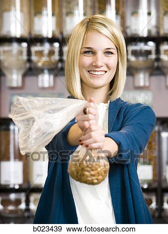 woman buying nuts at the supermarket View Large Photo Image Stock Photo - woman buying nuts at the supermarket. Fotosearch