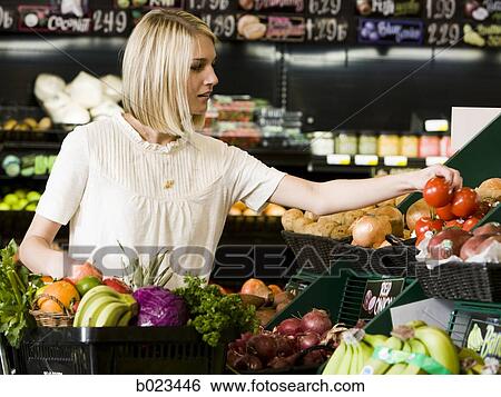 woman buying produce at the supermarket View Large Photo Image Stock Photograph - woman buying produce at the supermarket. Fotosearch