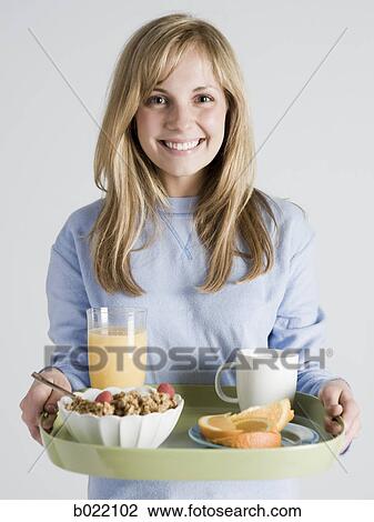 woman carrying breakfast on a tray View Large Photo Image Stock Image - woman carrying breakfast on a tray. Fotosearch