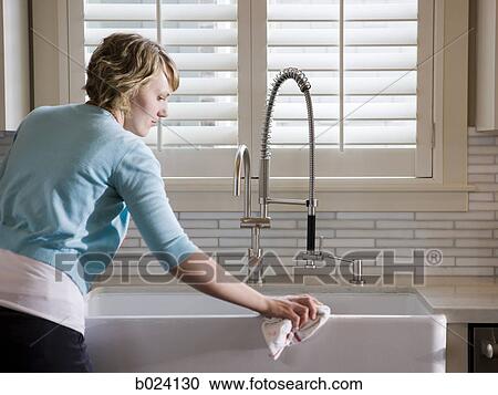 woman cleaning the kitchen sink View Large Photo Image Stock Image - woman cleaning the kitchen sink. Fotosearch