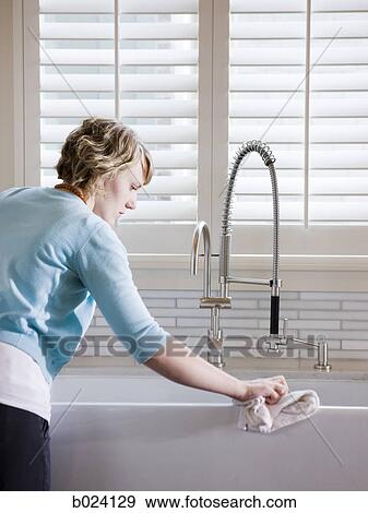 woman cleaning the kitchen sink View Large Photo Image Stock Photo - woman cleaning the kitchen sink. Fotosearch