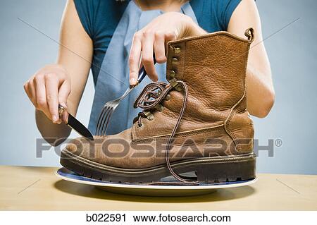 Stock Image - woman eating a boot. Fotosearch