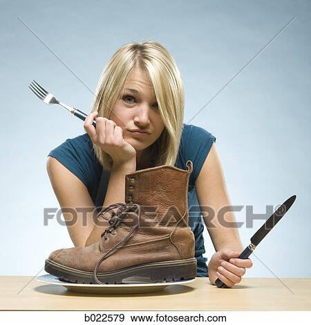 Stock Photo - woman eating a boot. Fotosearch