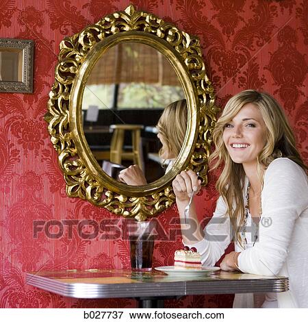 woman eating a piece of cake at a diner View Large Photo Image Stock Photo - woman eating a piece of cake at a diner. Fotosearch