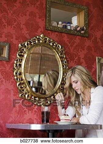 woman eating a piece of cake at a diner View Large Photo Image Stock Photo - woman eating a piece of cake at a diner. Fotosearch