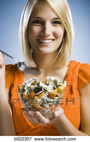 woman eating a salad made of money View Large Photo Image Stock Photo - woman eating a salad made of money. Fotosearch