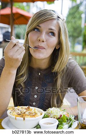 Stock Image - woman eating lunch. Fotosearch