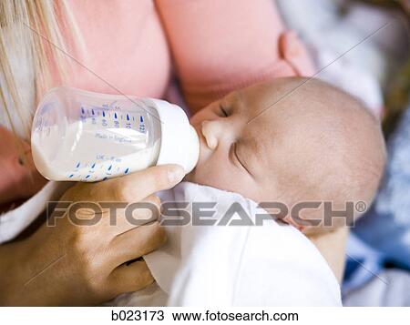 woman feeding her baby from a bottle View Large Photo Image Stock Image - woman feeding her baby from a bottle. Fotosearch