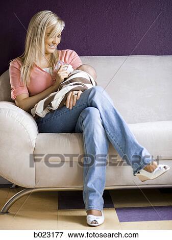 woman feeding her baby from a bottle View Large Photo Image Stock Photo - woman feeding her baby from a bottle. Fotosearch