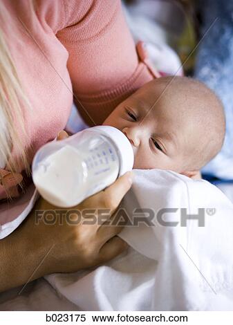 woman feeding her baby from a bottle View Large Photo Image Stock Photography - woman feeding her baby from a bottle. Fotosearch