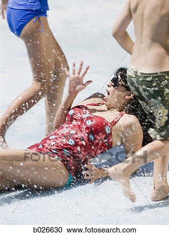 woman getting splashed at a waterpark View Large Photo Image Stock Image - woman getting splashed at a waterpark. Fotosearch
