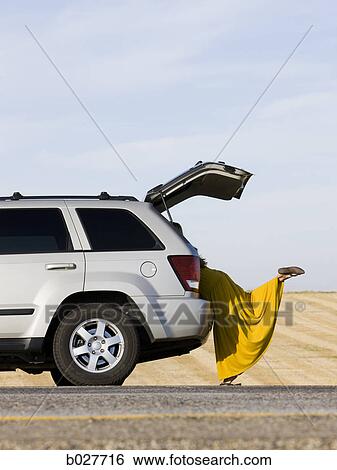 woman hanging out the back of her car on the side of the road View Large Photo Image Stock Photograph - woman hanging out the back of her car on the side of the road. Fotosearch
