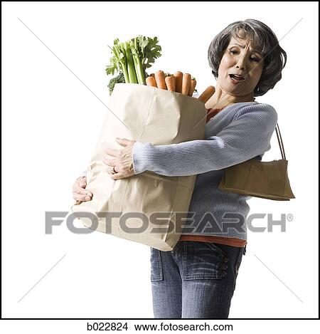 woman holding a bag of groceries View Large Photo Image Picture - woman holding a bag of groceries. Fotosearch