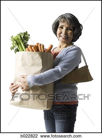 woman holding a bag of groceries View Large Photo Image Stock Image - woman holding a bag of groceries. Fotosearch