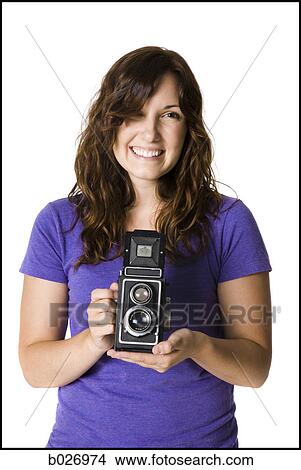 Picture - woman holding a camera. Fotosearch