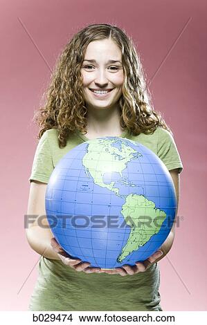 woman holding a globe View Large Photo Image Picture - woman holding a globe. Fotosearch