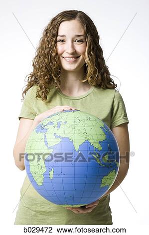 Stock Image - woman holding a globe. Fotosearch