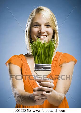woman holding a grass paintbrush View Large Photo Image Stock Image - woman holding a grass paintbrush. Fotosearch