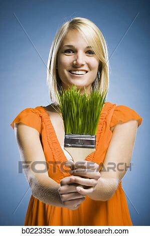 woman holding a grass paintbrush View Large Photo Image Stock Image - woman holding a grass paintbrush. Fotosearch