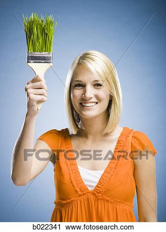 woman holding a grass paintbrush View Large Photo Image Stock Image - woman holding a grass paintbrush. Fotosearch