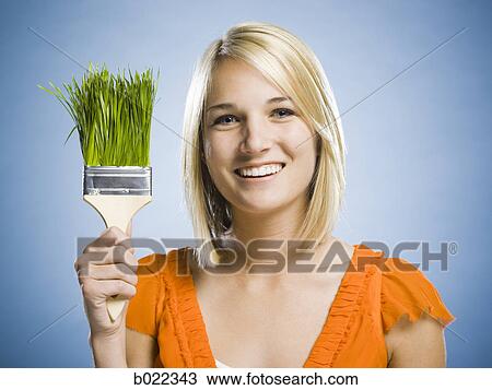 woman holding a grass paintbrush View Large Photo Image Stock Image - woman holding a grass paintbrush. Fotosearch