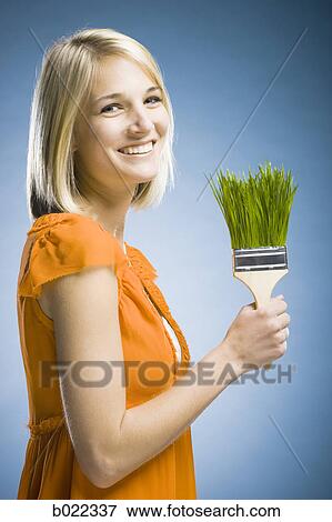 woman holding a grass paintbrush View Large Photo Image Stock Photo - woman holding a grass paintbrush. Fotosearch