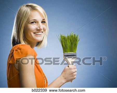 woman holding a grass paintbrush View Large Photo Image Stock Photo - woman holding a grass paintbrush. Fotosearch