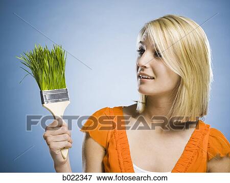 woman holding a grass paintbrush View Large Photo Image Stock Photo - woman holding a grass paintbrush. Fotosearch