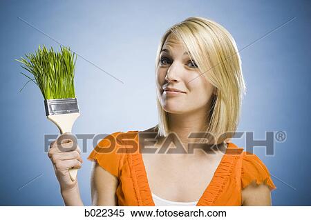 woman holding a grass paintbrush View Large Photo Image Stock Photography - woman holding a grass paintbrush. Fotosearch